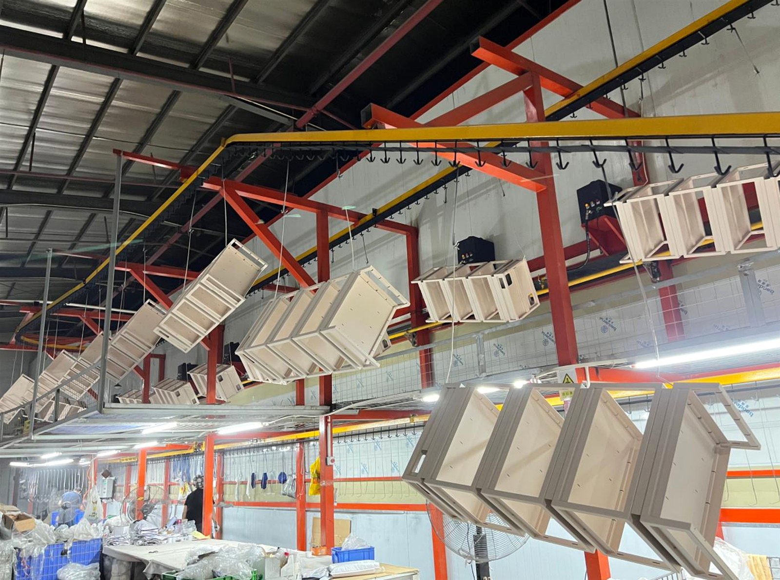 Retail fixture components moving through the BEVIS powder coating line