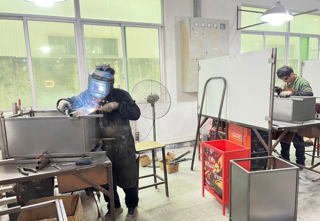 BEVIS metal fabrication team welding retail fixture frames