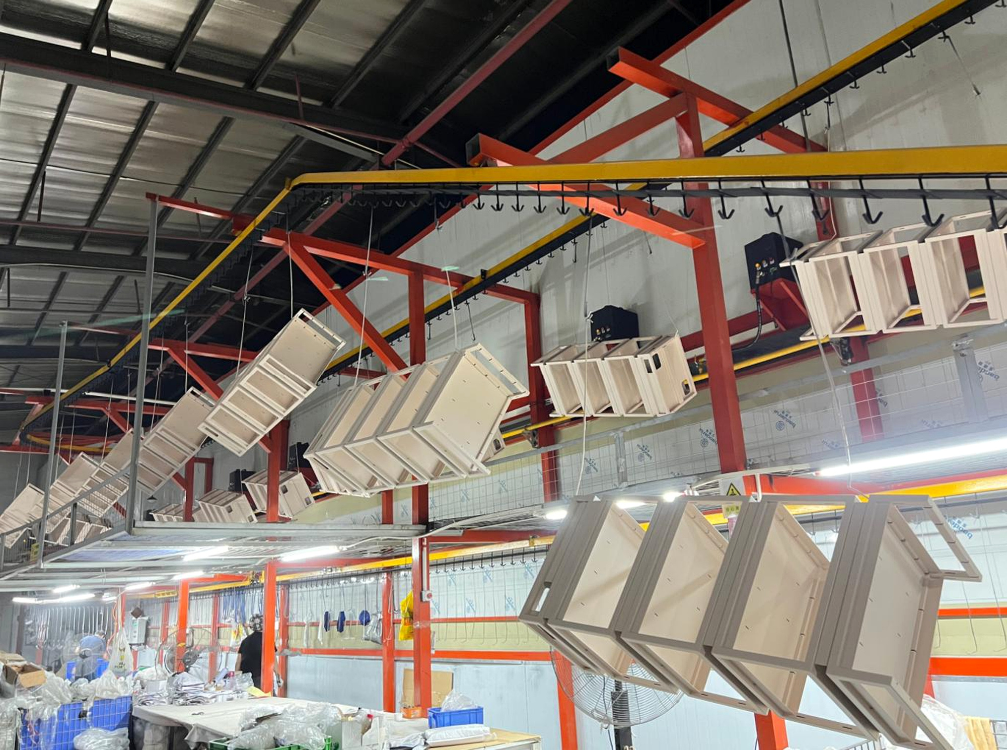 Display components moving through the BEVIS powder coating line
